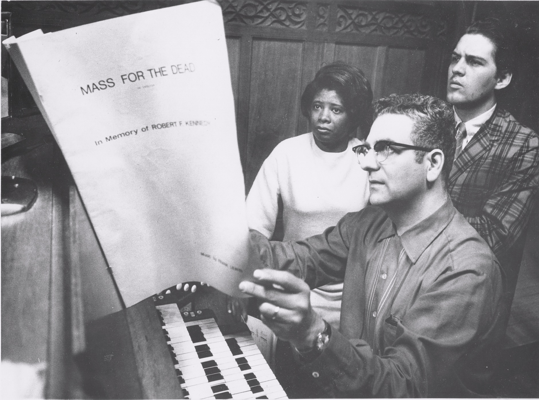 Frank Lewin preparing Kennedy Mass with soloists Sylvia Jones + Leo Goeke for prem 05-27-1969